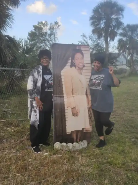 Tut's Marker volunteers with image of Willie M. Lattimore Davis